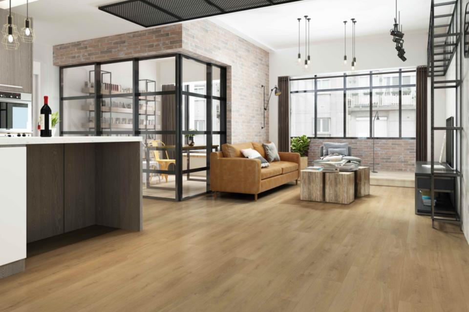 warm tone wood look flooring in open concept kitchen and living room with industrial decor.